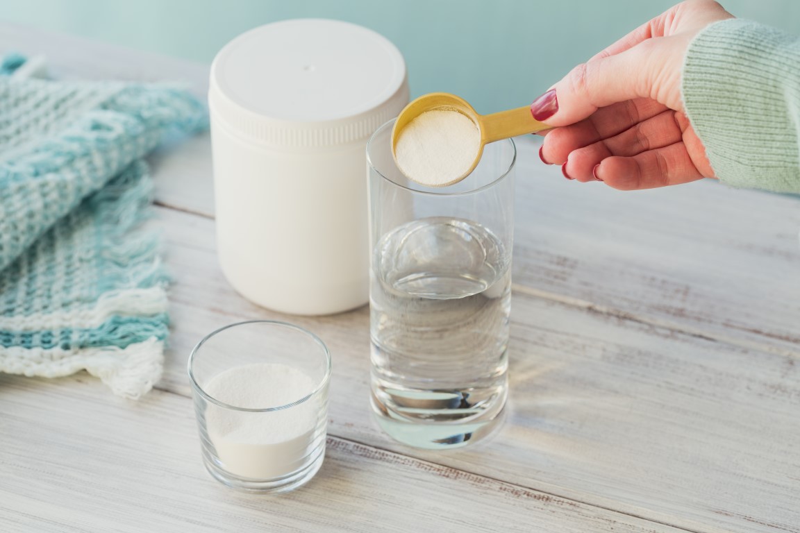 Collagen,Powder,In,Bowl,,Glass,Of,Water,And,Measure,Spoon